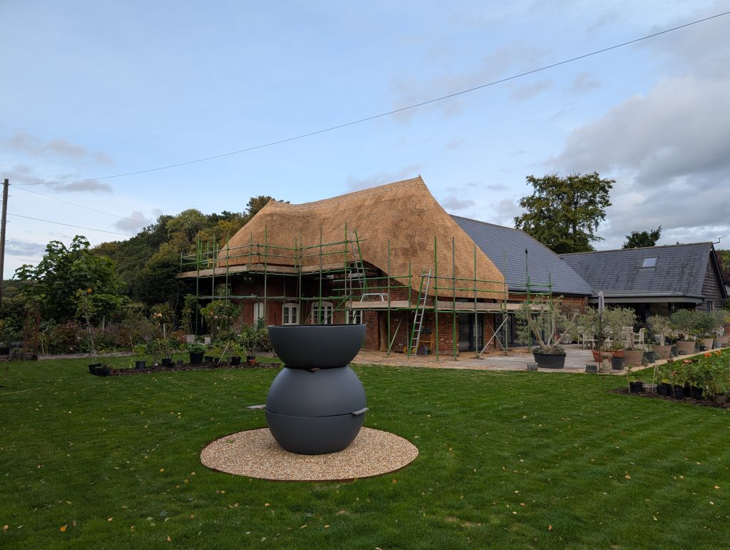 rethatched reed roof in Farley, Wiltshire with wire netting