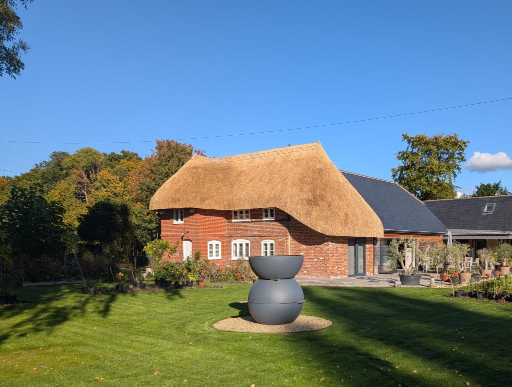 Newly thatched cottage roof with flush ridge in Wiltshire
