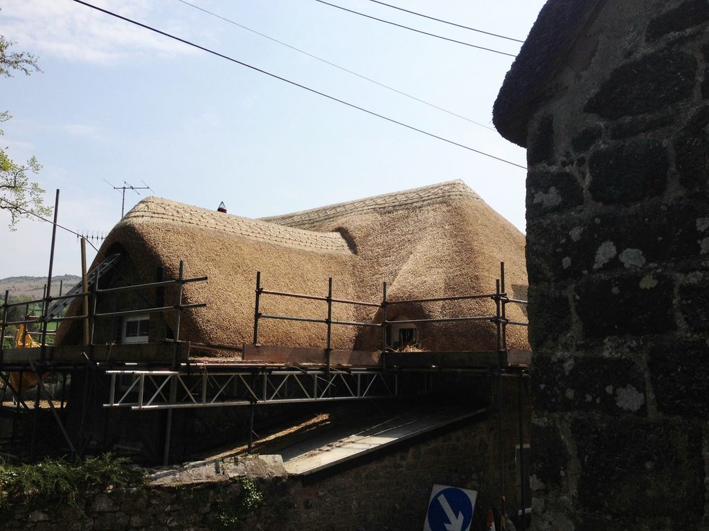 Newly completed thatched roof on heritage property in Devon