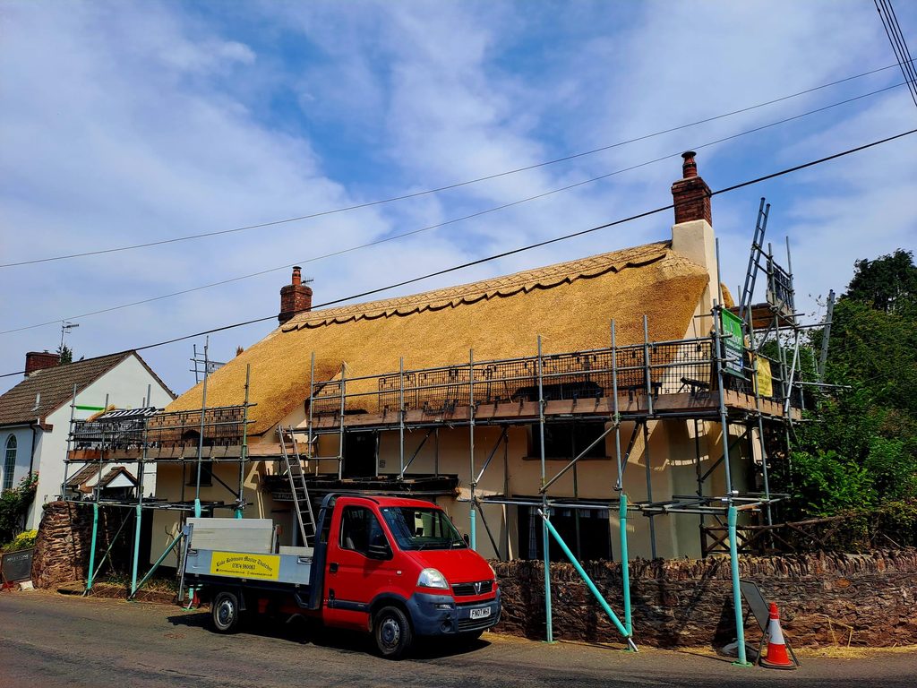 Full Re-Thatch in water reed finished project in Monksilver, Somerset with Luke Robinsons truck in front of house